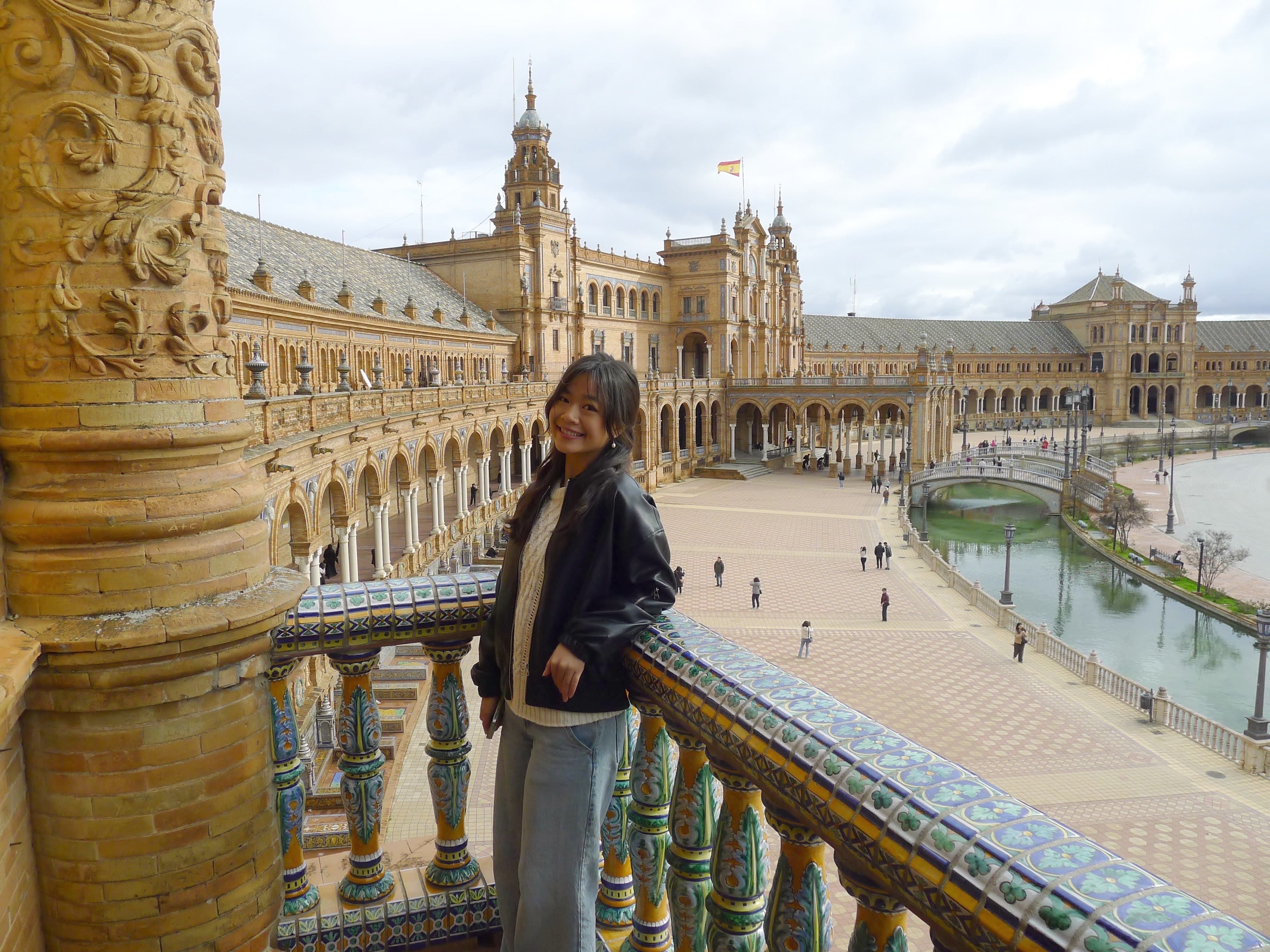 Doris on a tiled balcony overlooking a large plaza